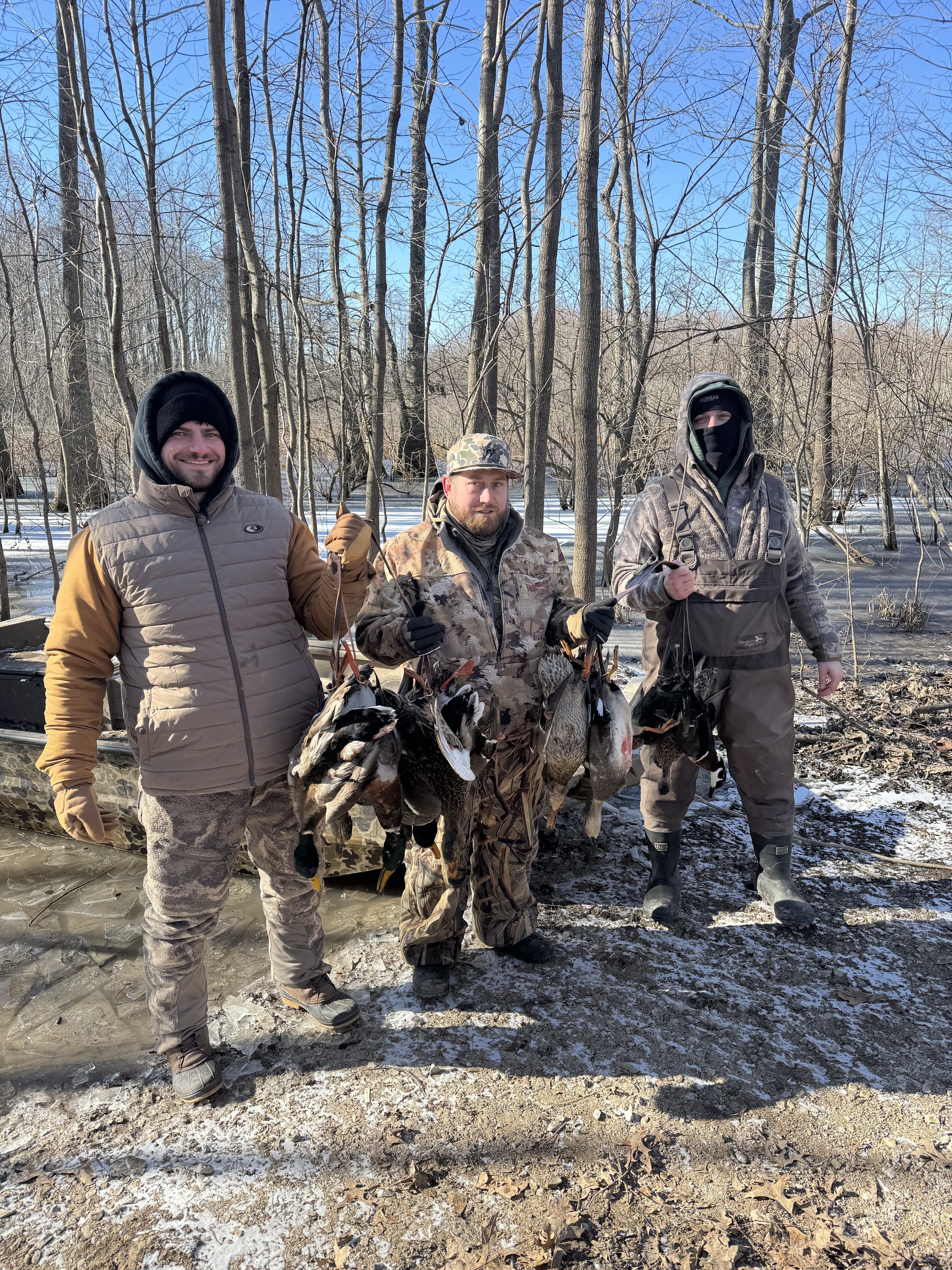 Three hunters with their mallard harvest at Oak Meadow Estate